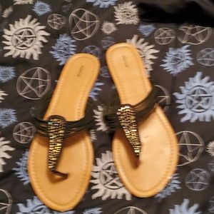 Black flip flops with a goldtone stones